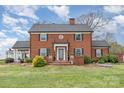 Charming two-story brick home with a manicured lawn, mature landscaping, and a classic architectural design at 1783 Reepsville Rd, Lincolnton, NC 28092