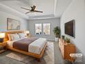 Serene main bedroom with a tray ceiling, lots of natural light, and modern furnishings at 2018 Hyacinth Ct, Denver, NC 28037