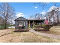 Attractive single-story home with neat landscaping, American flag, and covered porch at 212 Sloan St, Belmont, NC 28012