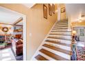 Charming stairway with uplifting quotes and a view into the living room with a fireplace at 2324 Chestnut Ln, Matthews, NC 28104