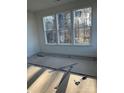 Well-lit bedroom with three large windows overlooking backyard at 2358 Fay Jones Rd, Denver, NC 28037