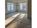 Bright living room with natural light, chandelier and large windows at 2358 Fay Jones Rd, Denver, NC 28037