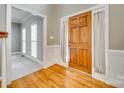 Inviting foyer with hardwood flooring, white trim, and a classic wooden front door at 2955 Eppington South Dr, Fort Mill, SC 29708