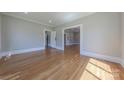 A spacious living room with hardwood floors, highlighted by a doorway leading to other rooms and classic trim at 410 E Arch St, Lancaster, SC 29720