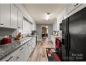 Galley kitchen with granite counters, stainless appliances, and ample cabinet space at 468 Wilhelm Ne Pl, Concord, NC 28025