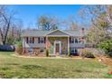 Daytime exterior view of a two-story home with stone accents, landscaped lawn, and vibrant curb appeal at 5230 Northview Dr, Hickory, NC 28601