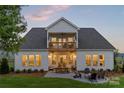 Spacious backyard featuring a stone patio with a fire pit and outdoor seating at 5312 Allburn Pkwy, Concord, NC 28027