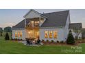 Spacious backyard featuring a stone patio with a fire pit and outdoor seating at 5312 Allburn Pkwy, Concord, NC 28027