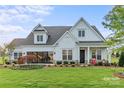 Charming two-story home with well-manicured lawn and inviting front porch at 5312 Allburn Pkwy, Concord, NC 28027