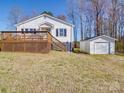 Features an expansive wooden deck and a convenient detached garage in a well-maintained backyard at 5985 Bertie Ave, Salisbury, NC 28147