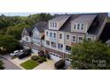 Overhead view of townhomes, showing garages, lush greenery, and multiple parked cars at 609 Sunfish Ln, Tega Cay, SC 29708