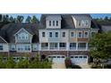 Aerial view of townhomes with stone accents, multiple windows, and well-maintained landscaping at 609 Sunfish Ln, Tega Cay, SC 29708