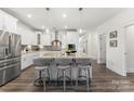 Modern kitchen featuring a large center island with counter seating and stainless steel appliances at 619 R L Stowe Rd, Belmont, NC 28012