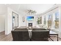 Bright living room with fireplace, white trim, ceiling fan, and large windows at 619 R L Stowe Rd, Belmont, NC 28012