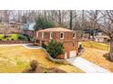 View of the brick home featuring an attached garage and surrounding landscape at 651 25Th Nw Ave, Hickory, NC 28601
