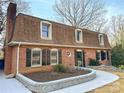 Brick home featuring a garden bed, dormer windows and a circular window at 651 25Th Nw Ave, Hickory, NC 28601