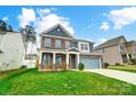 Charming two-story home with brick and siding, a two-car garage, and a lush green lawn at 670 Belle Grove Dr, Clover, SC 29710