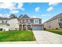 Beautiful two-story home with a brick and siding exterior, a two-car garage, and a well-kept lawn at 670 Belle Grove Dr, Clover, SC 29710