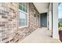 Inviting front porch featuring brick accents, white columns, and a cozy entrance at 670 Belle Grove Dr, Clover, SC 29710