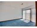 Inviting bedroom with light filtering through vertical blinds with a lovely lake view from the sliding glass door at 7831 Spinnaker Bay Dr # 106, Sherrills Ford, NC 28673