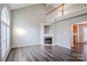Bright living room with vaulted ceiling, fireplace, and large arched window at 8545 Filbert Ln, Charlotte, NC 28215