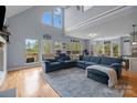 Spacious living room with a large sectional couch, high ceilings, and generous natural light at 9004 Cebu Ct, Fort Mill, SC 29708