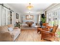 Spacious living room featuring hardwood floors, a pool table, and comfortable seating at 9417 Valley Rd, Charlotte, NC 28270