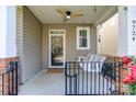 Inviting front porch with a charming swing, ceiling fan, and a view of the neighborhood at 9724 Cadman Ct, Cornelius, NC 28031