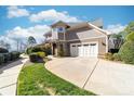 Charming home exterior with a two-car garage, stone accents, lush greenery and a concrete driveway at 101 N Cove Key Ln, Mooresville, NC 28117