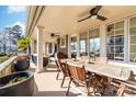 Covered outdoor patio with ceiling fans and views of the lake at 101 N Cove Key Ln, Mooresville, NC 28117