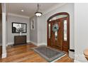 Inviting entryway with hardwood floors, detailed wood door, and natural light from sidelight windows at 10209 New Town Rd, Marvin, NC 28173