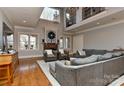 Spacious living room with high ceilings, stone fireplace, hardwood floors, and abundant natural light at 10209 New Town Rd, Marvin, NC 28173
