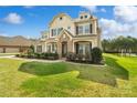 Beautiful two-story home with manicured lawn, stone accents, and inviting front porch at 1022 Torrens Dr, Monroe, NC 28110