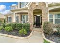Charming stone archway and covered entry lead to the home's front door at 1022 Torrens Dr, Monroe, NC 28110
