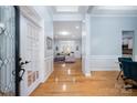 Welcoming foyer with hardwood floors, wainscoting, and views into the open-concept living spaces at 1061 Verbena Ct, Tega Cay, SC 29708