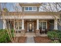 Inviting front porch featuring stone columns and seating area, perfect for relaxing and enjoying the outdoors at 1061 Verbena Ct, Tega Cay, SC 29708