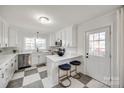 Modern white kitchen with stainless steel appliances and a chic checkered floor at 1081 Evergreen Cir, Rock Hill, SC 29732