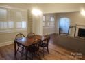 Bright dining room featuring plantation shutters and a classic chandelier above a wood table at 109 Oakland Ave, Chester, SC 29706