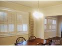Bright dining room featuring plantation shutters and a classic chandelier above a wood table at 109 Oakland Ave, Chester, SC 29706