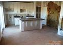 Unfinished kitchen with island, granite countertops, cabinets, and exposed drywall, ready for customization at 128 Peppervine Ln, Statesville, NC 28625