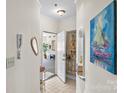 Inviting hallway showcases a decorative painting and a view into the open-concept living area of the condo at 1410 4Th Street Nw Dr # 205, Hickory, NC 28601