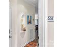 Bright hallway featuring a decorative display niche and a colorful rug, leading into the living space at 1410 4Th Street Nw Dr # 205, Hickory, NC 28601