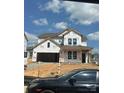 New construction home featuring a two-car garage and covered entryway awaiting finishing touches at 162 Holsworthy Dr, Mooresville, NC 28115