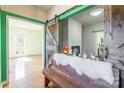 Inviting foyer showcasing a decorative bench, barn door, and view of the fireplace at 1847 Bertha Knight Rd, Lancaster, SC 29720