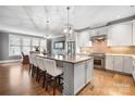 Spacious kitchen showcasing a center island with seating, stainless steel appliances, and hardwood floors at 2305 Flintwood Ln, Charlotte, NC 28226