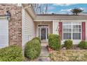 Close-up of a front entrance of a charming home with a decorative wreath and seasonal decor at 242 Tradition Way, Rock Hill, SC 29732