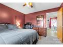 Primary bedroom with a ceiling fan, a large bed, dresser and an adjacent room at 244 Branchwood Cir, Kings Mountain, NC 28086