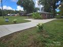Well-maintained brick home with new concrete driveway and green lawn at 245 College E Ave, Shelby, NC 28152