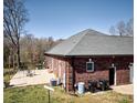Brick home featuring a concrete patio and a well-manicured lawn at 28926 Hartsell Rd, Albemarle, NC 28001