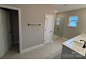 Bathroom featuring double sinks, tiled floors, glass shower, and natural lighting at 3105 Beacon Heights Rd, Indian Land, SC 29707